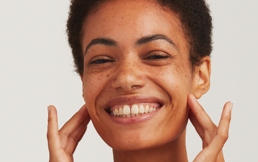 Dermatica - Smiling Woman Applying Treatment