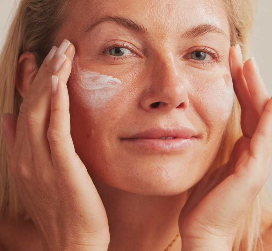 Dermatica - Woman applying sunscreen