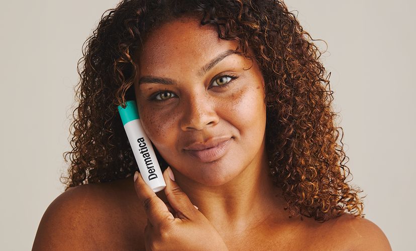 Dermatica - Smiling woman holding Dermatica bottle in the hand